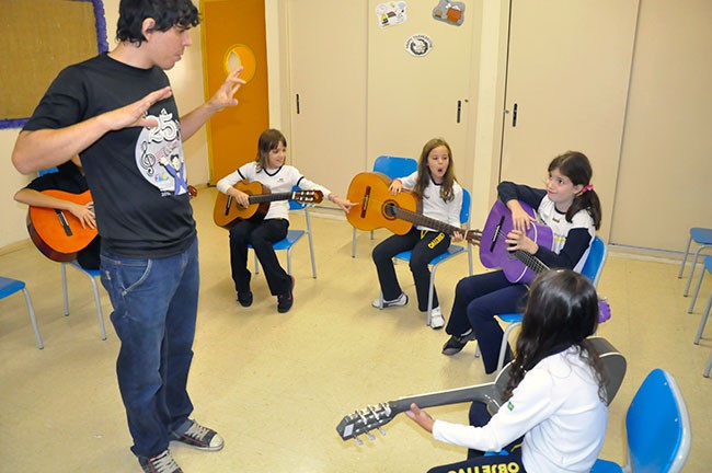 Alunos tocando violão